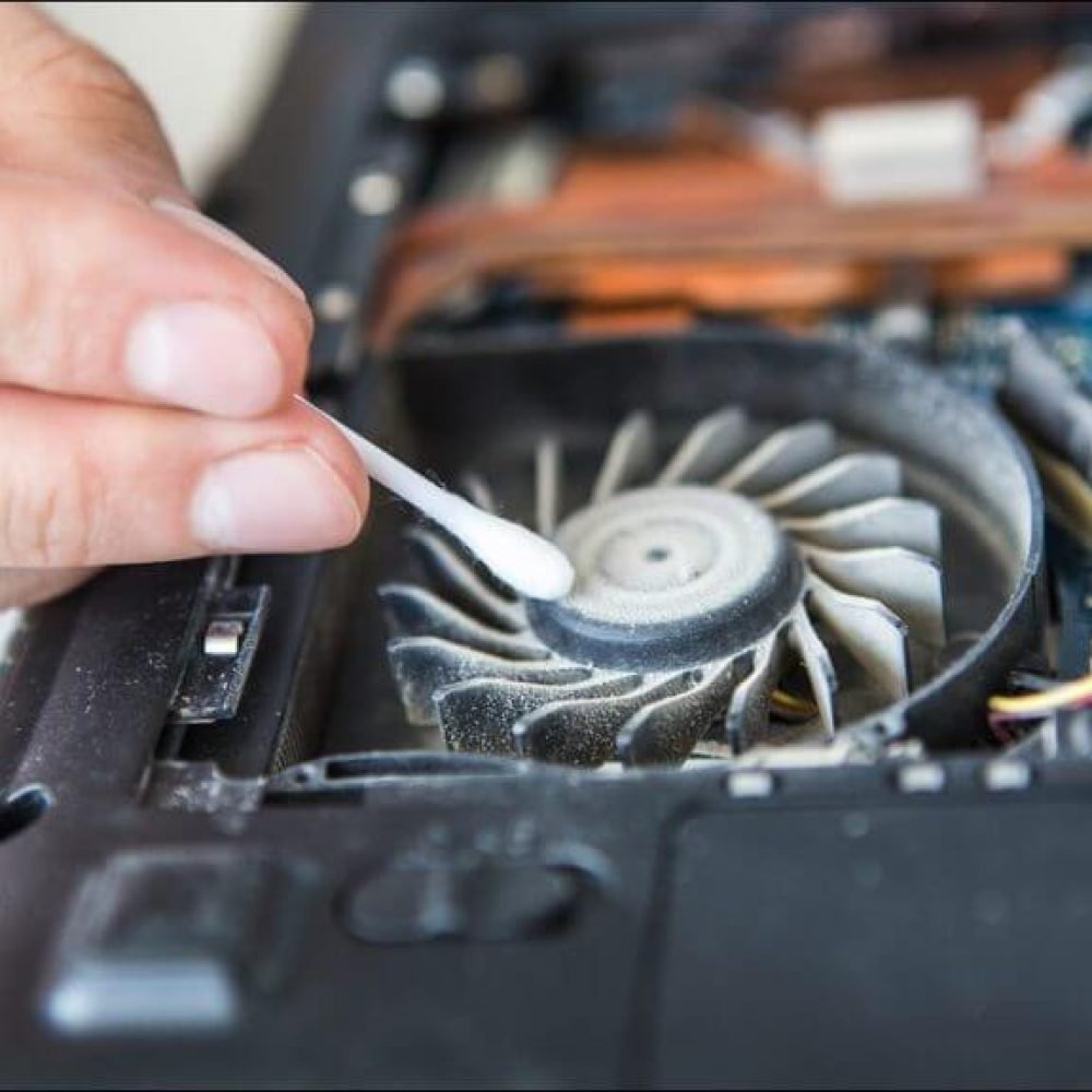 Person-cleaning-dust-out-of-a-laptop